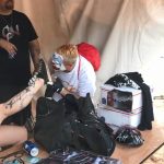 FlipFlop The Clown worshipping dirty and muddy shoes at the 2017 Gathering of the Juggalos