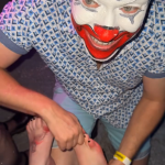FlipFlop The Clown massaging feet at the 2025 New Year's Eve Party at the Sausage Castle